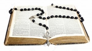 rosary-beads-cross-lying-open-page-bible-isolated-white-background-29899495 2
